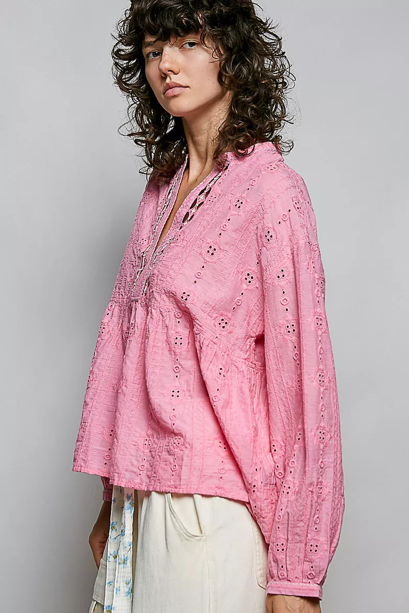 Pink eyelet lace blouse with split V neck and long sleeves; relaxed side silhouette