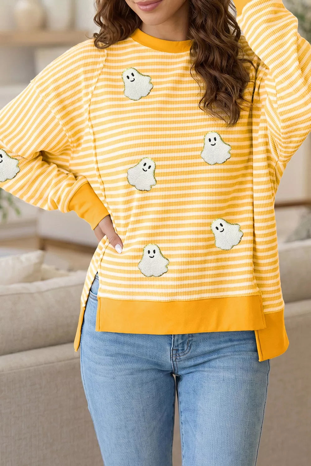 Yellow and white striped long-sleeve top with small ghost patches, crew neck