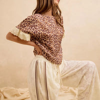 Leopard print top with lace-trimmed edges and cream striped lounge shorts