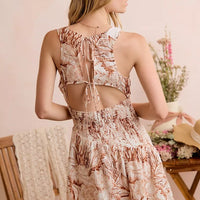 Back view: taupe shell print smocked mini dress with open-back cutout