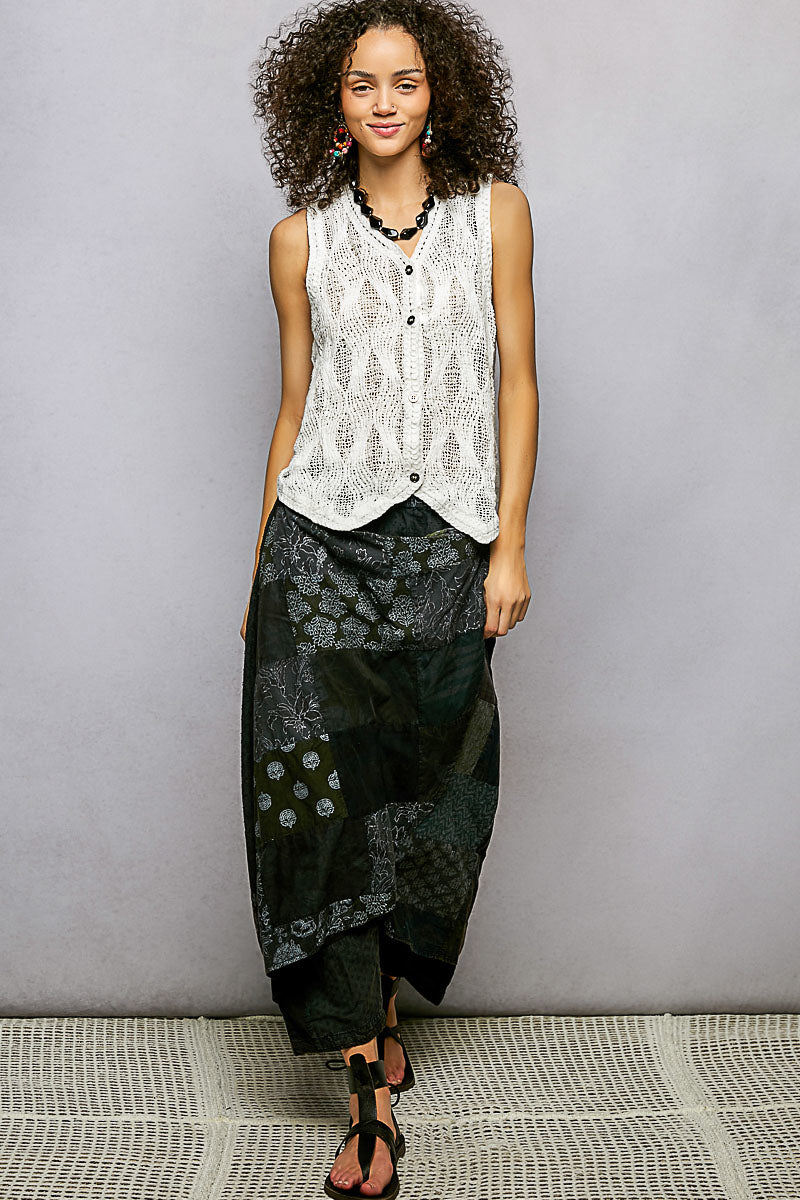 Off-white sleeveless V-neck sweater vest, front button details on textured knit