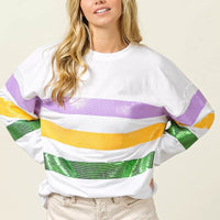 Off-white round-neck sweatshirt with sequined purple, yellow, and green chest stripe