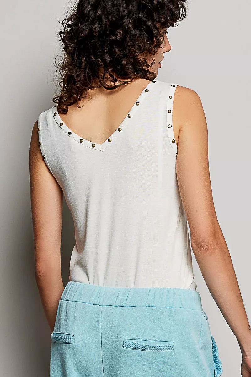 Cream backless tank with studded shoulder trim and V-back neckline