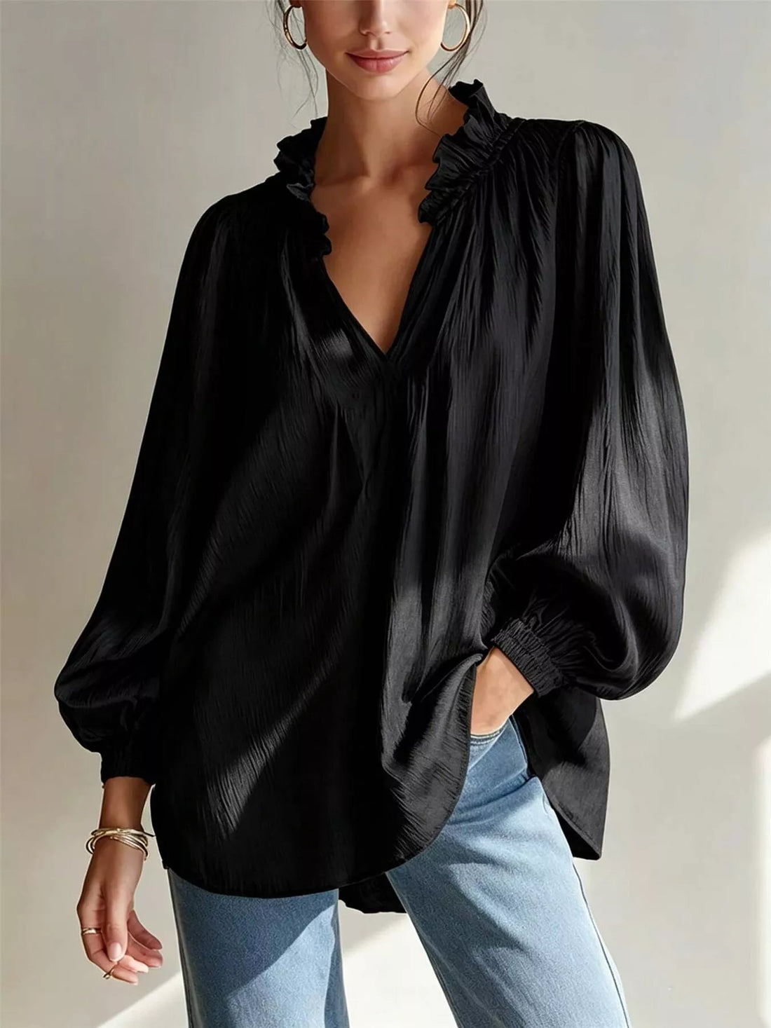 Black ruffle-trim long-sleeve blouse with V-neck and gathered shoulder ruffles