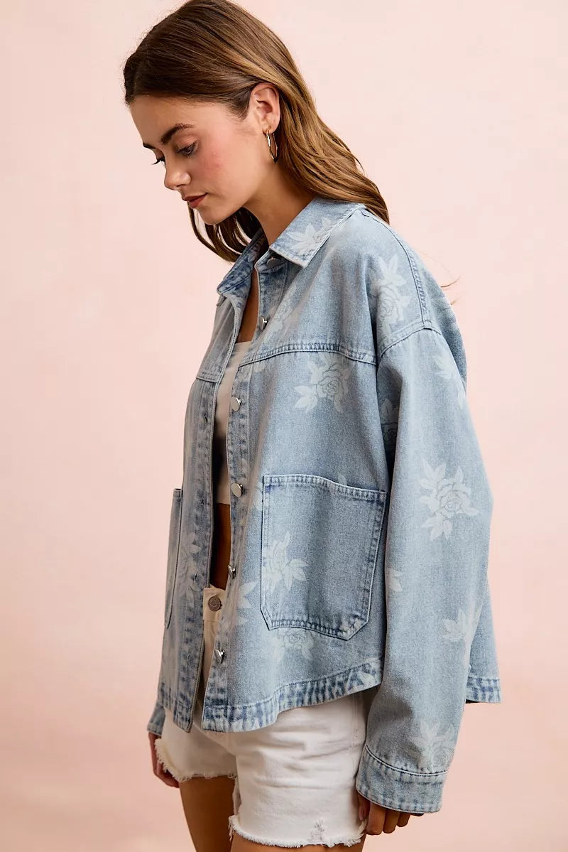 Light blue washed denim jacket with white floral print and chest pockets
