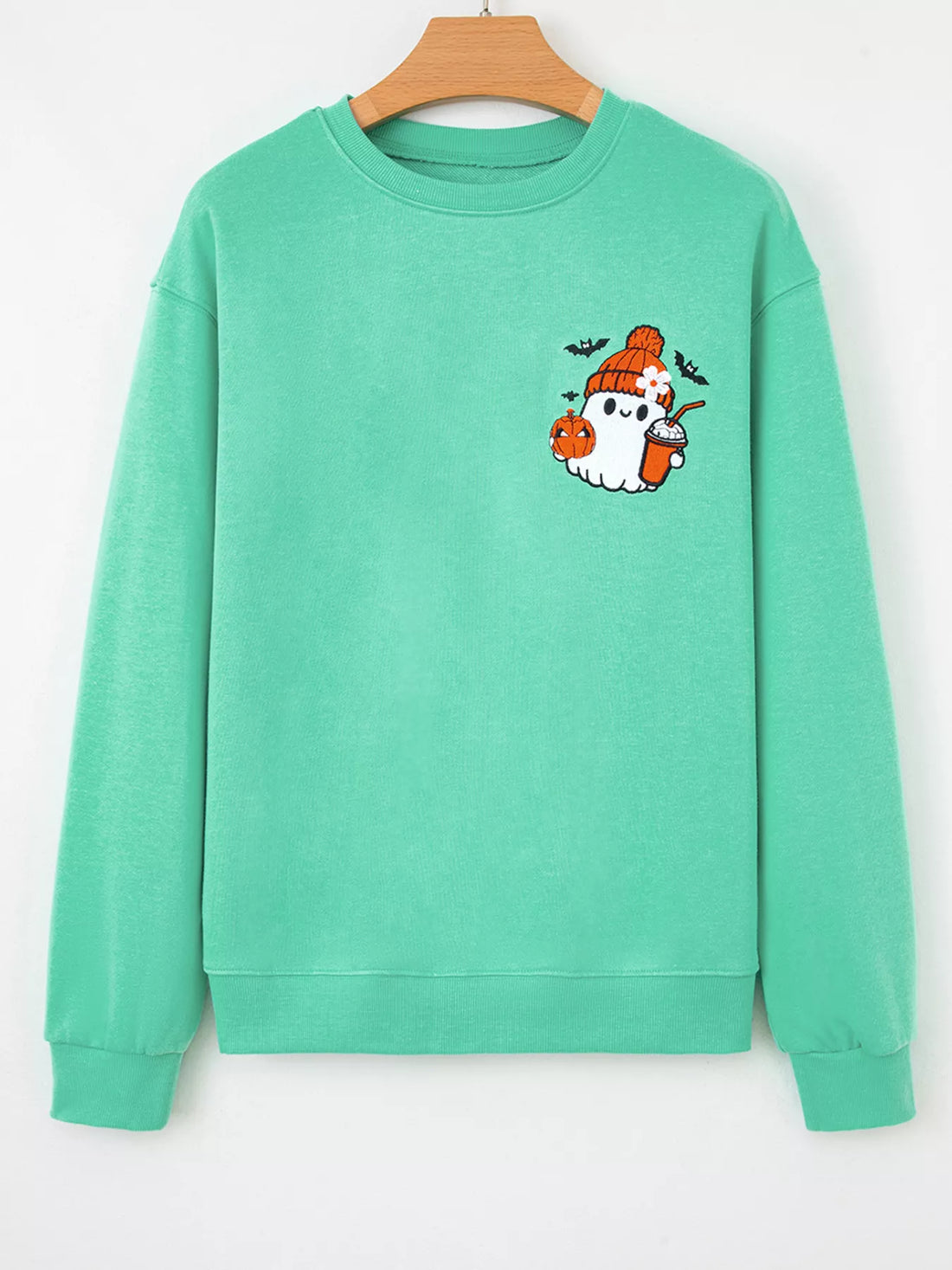 Turquoise crewneck sweatshirt with ghost and pumpkin embroidery, front view