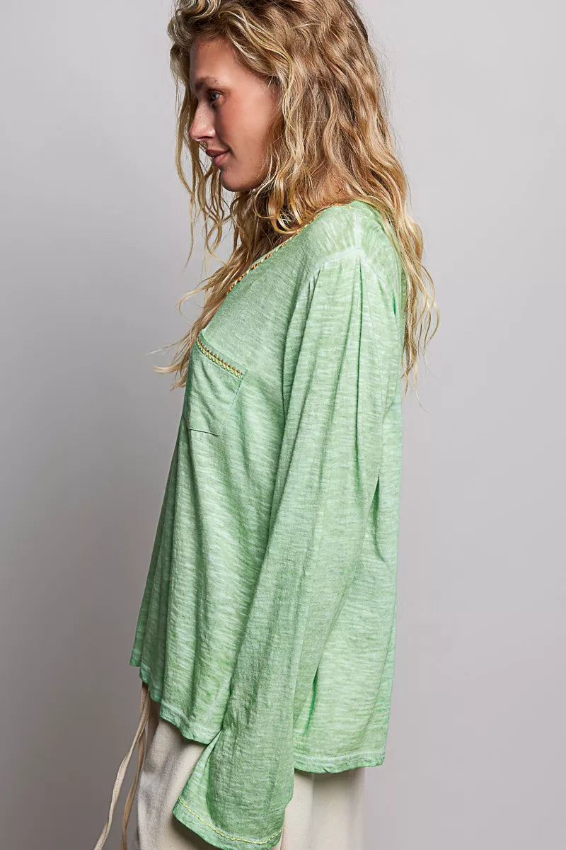 Light green V-neck knit long sleeve top with contrast-stitched neckline