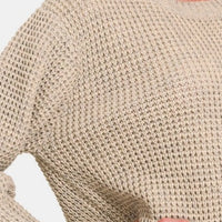 Beige waffle knit sweater close-up with ribbed cuff and textured fabric