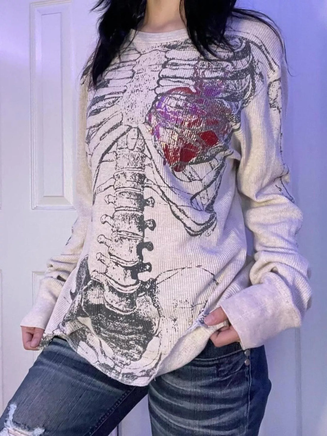 White long sleeve t-shirt with skeleton and heart graphic on front