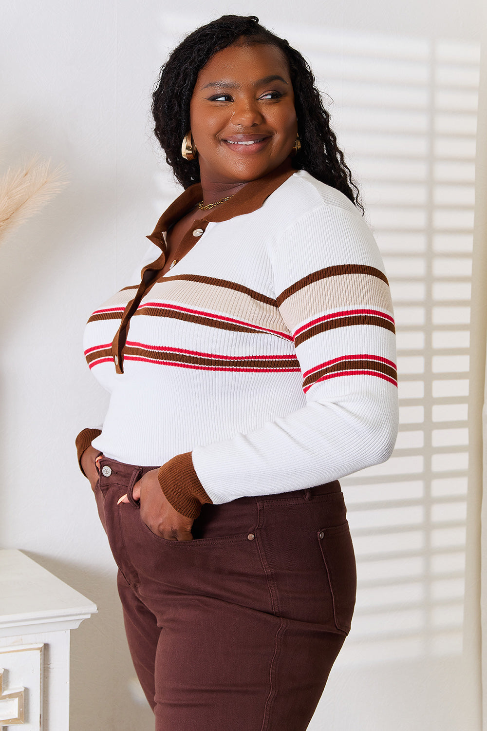 White striped collared rib-knit top with front buttons and long striped sleeves, side view