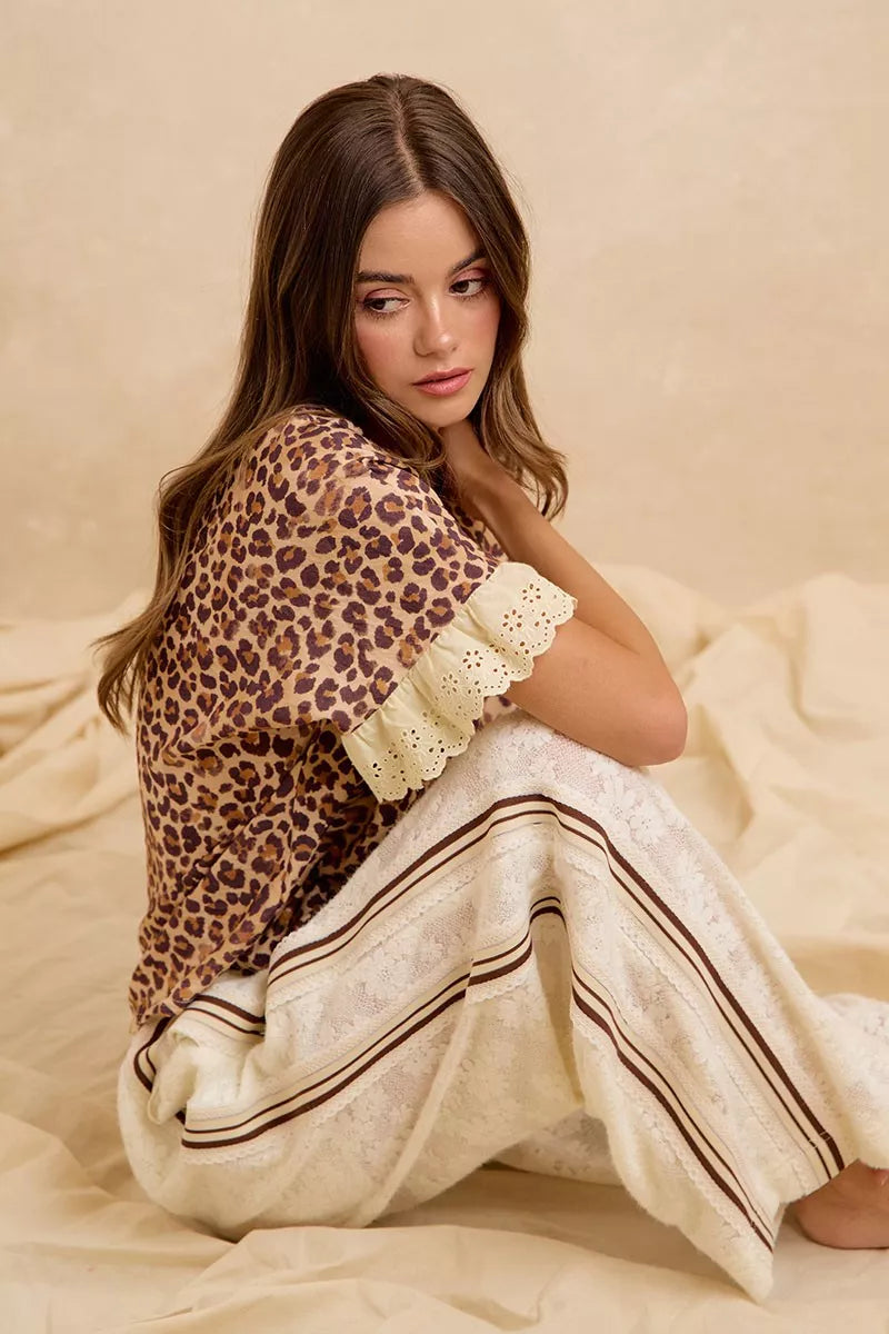 Leopard print ruffled top with eyelet lace sleeves and scalloped trim