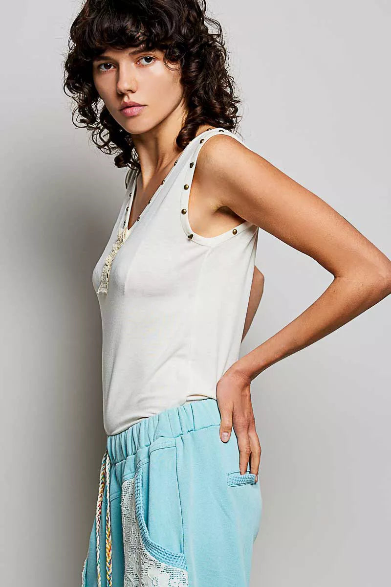 Cream button-front tank with studded neckline trim and ruffle placket