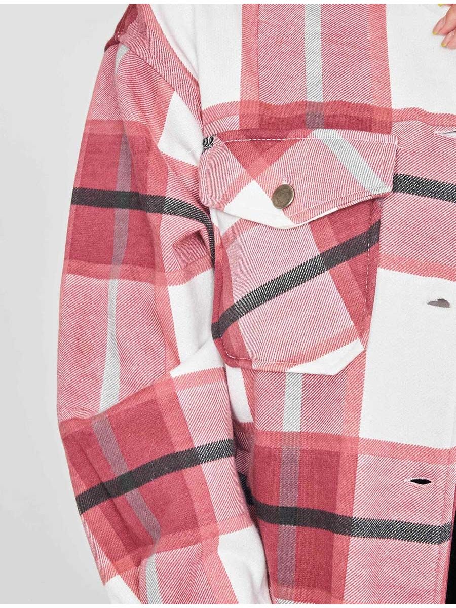 Close-up of women’s plaid shacket cuffs and chest flap pockets with metal buttons
