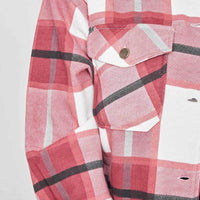 Close-up of women’s plaid shacket cuffs and chest flap pockets with metal buttons