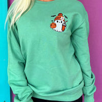 Turquoise crewneck sweatshirt with embroidered ghost and pumpkin patch on front