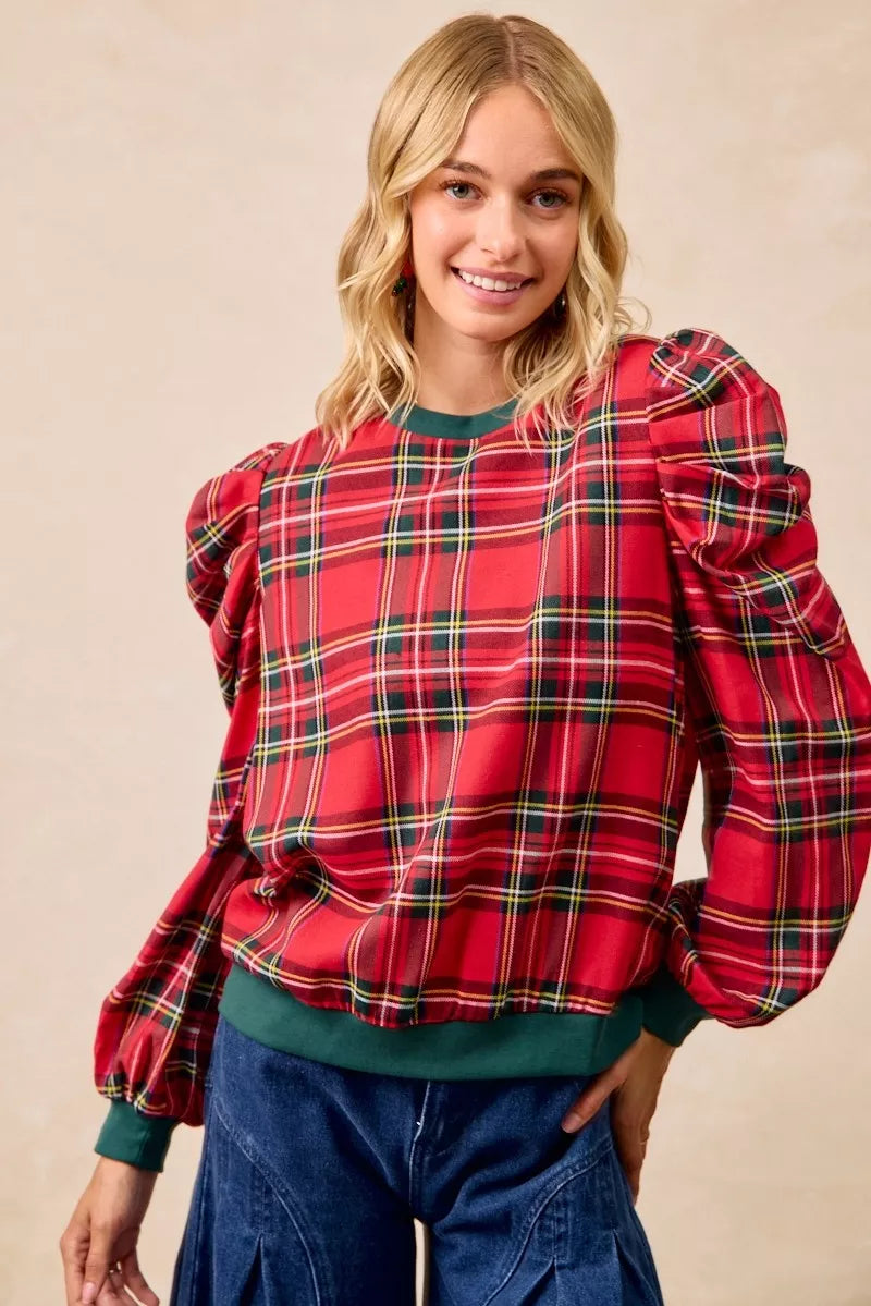 Red plaid puff-sleeve top with exaggerated shoulders and green ribbed cuffs at wrists