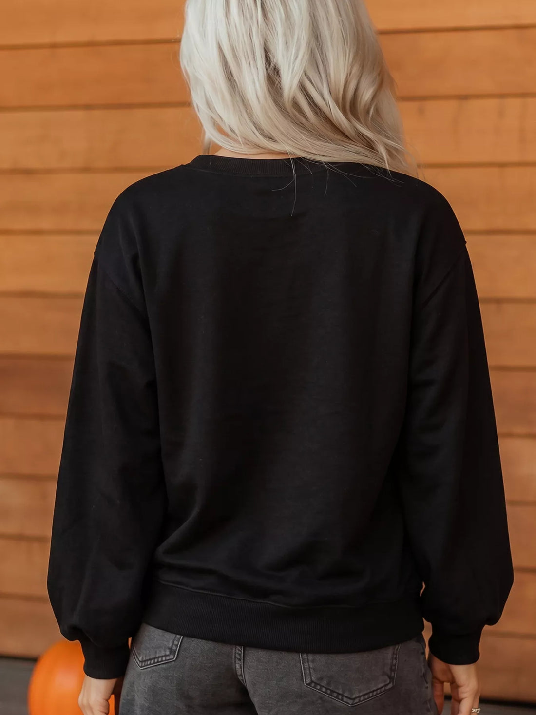 Black long-sleeve crewneck sweatshirt, plain back view