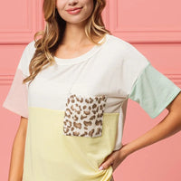 Color-block crew-neck top with leopard front pocket; white base with mint sleeves and yellow panel