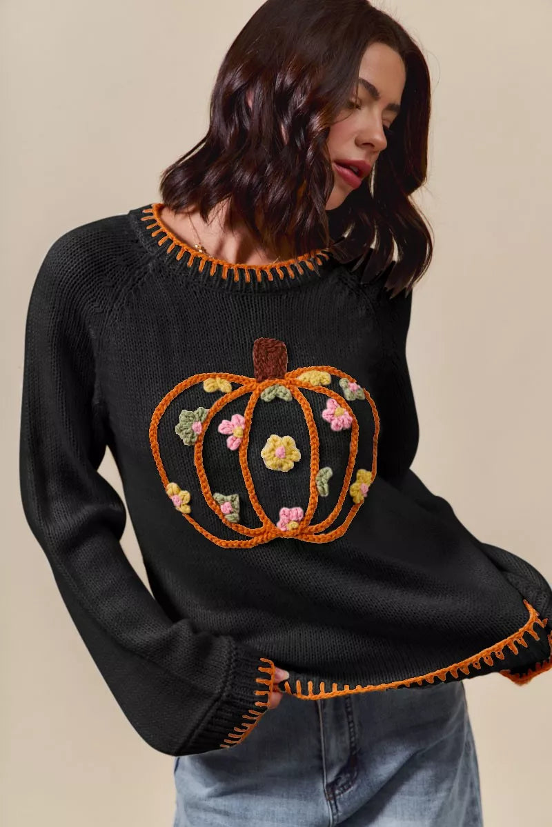 Black knit sweater with embroidered pumpkin and floral patchwork front