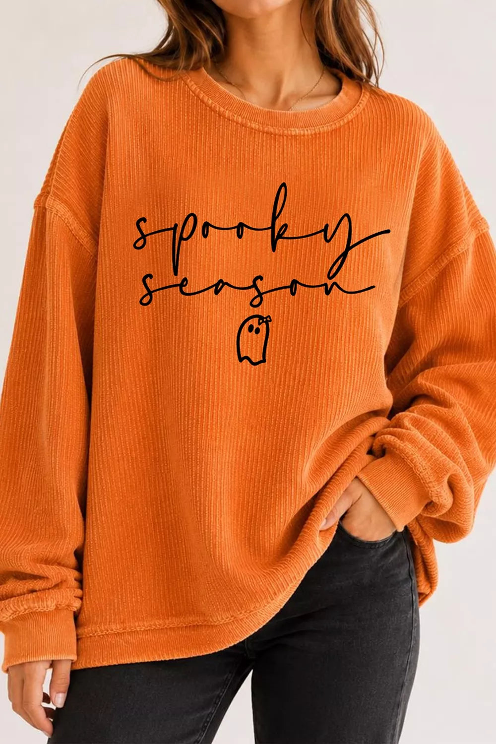 Orange ribbed pullover sweatshirt featuring “sprooky season” text and ghost icon