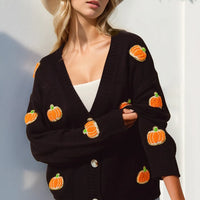 Black V-neck cardigan with long sleeves, orange pumpkin patches, and button front