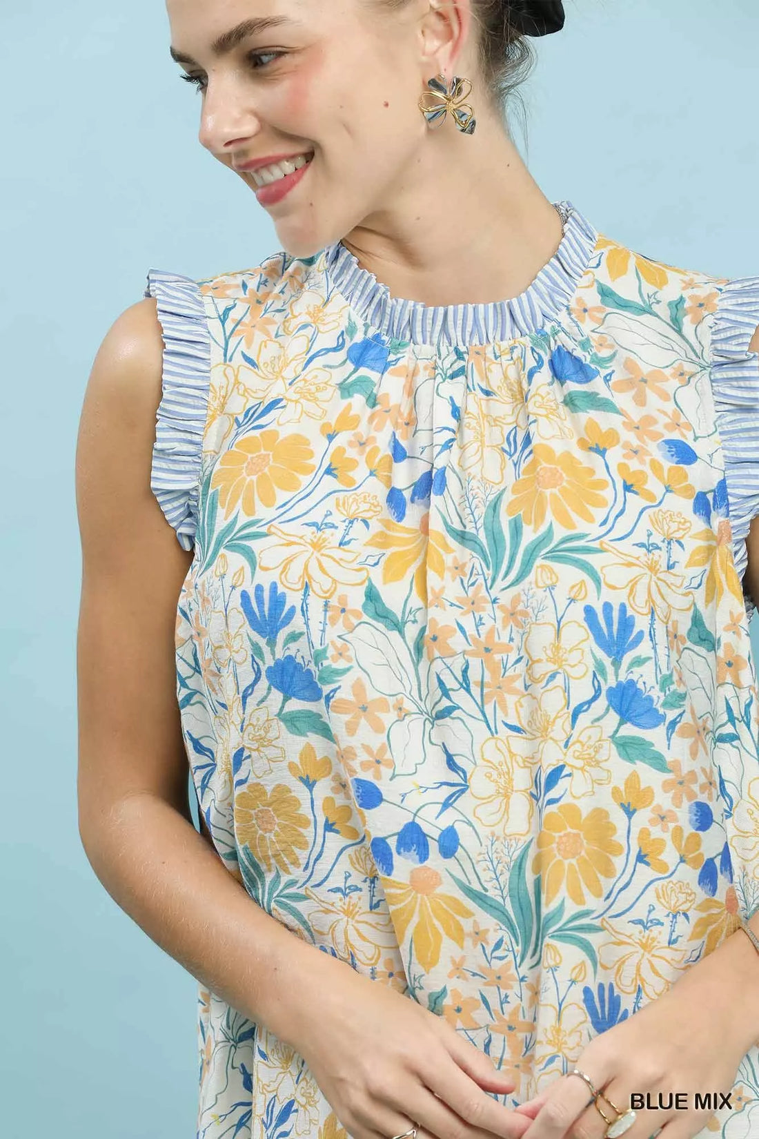 Floral babydoll dress close-up, gathered ruffled neckline, blue and yellow botanical print