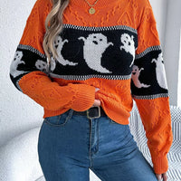 Orange ghost-pattern knit sweater with striped trim at the cuffs and neckline