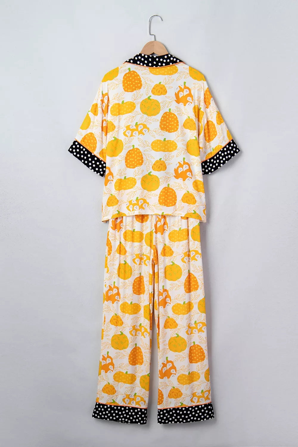 Laid-out back view of pumpkin print lounge pajama set with polka-dot-trim collar and cuffs