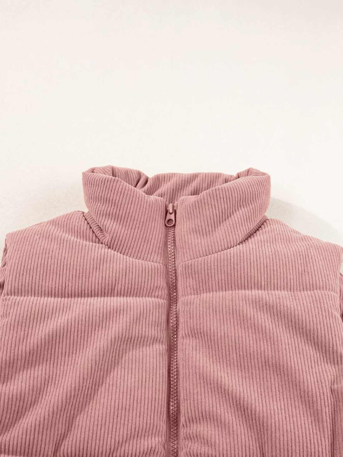 Dusty pink corduroy puffer vest hoodless stand collar with front zipper.