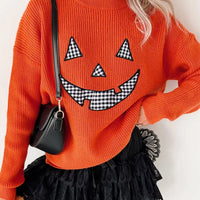 Orange Halloween sweater with jack-o-lantern face print and long sleeves