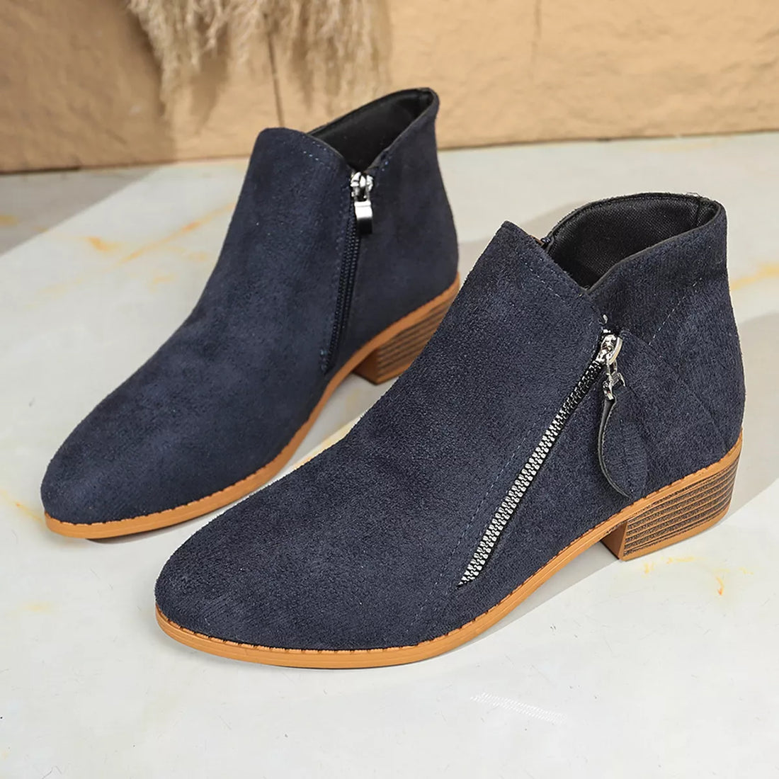 Dark navy point-toe block heel ankle boots with side zipper and stacked heel