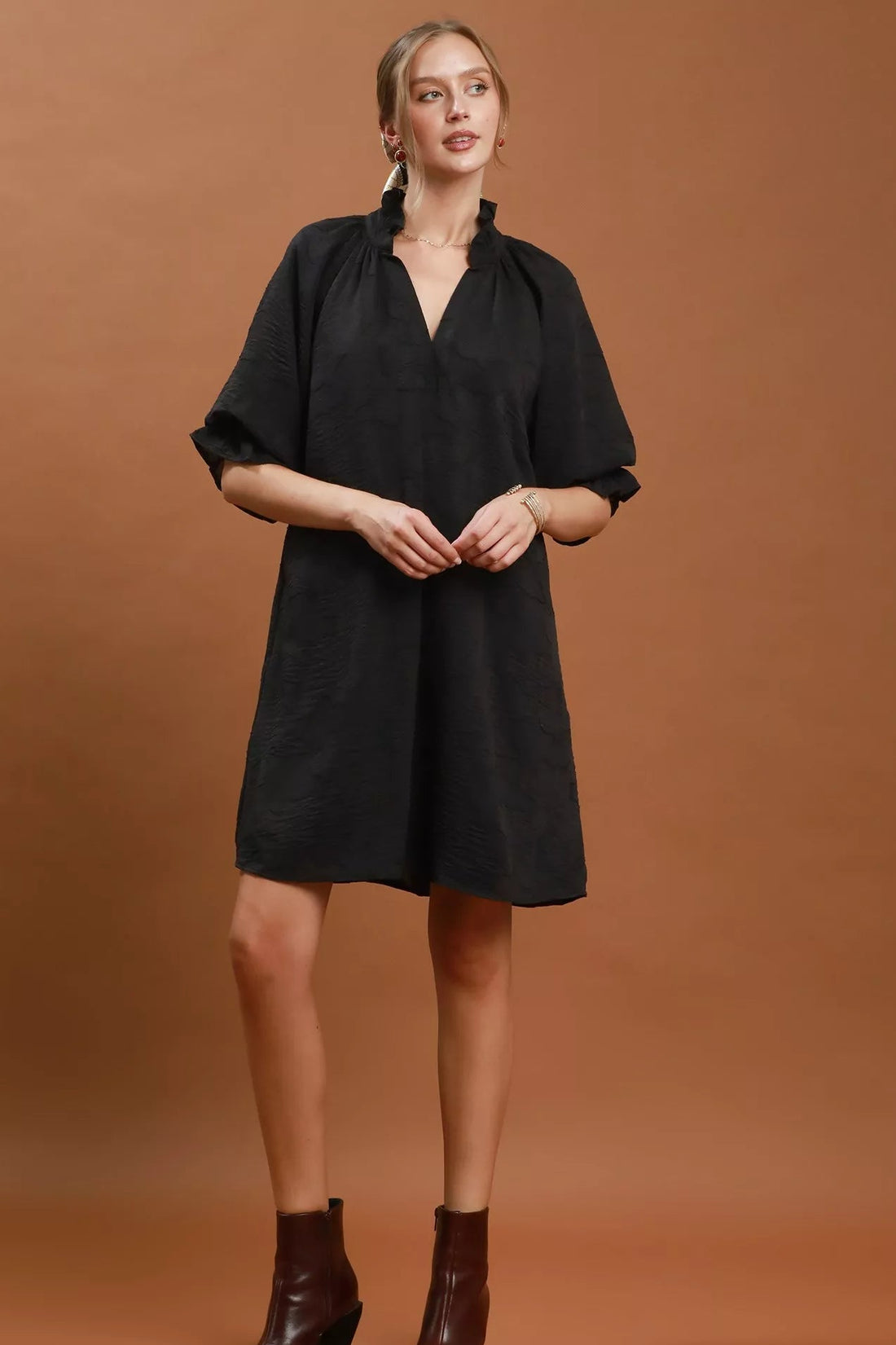 Black V-neck textured mini dress with short sleeves and relaxed A-line fit