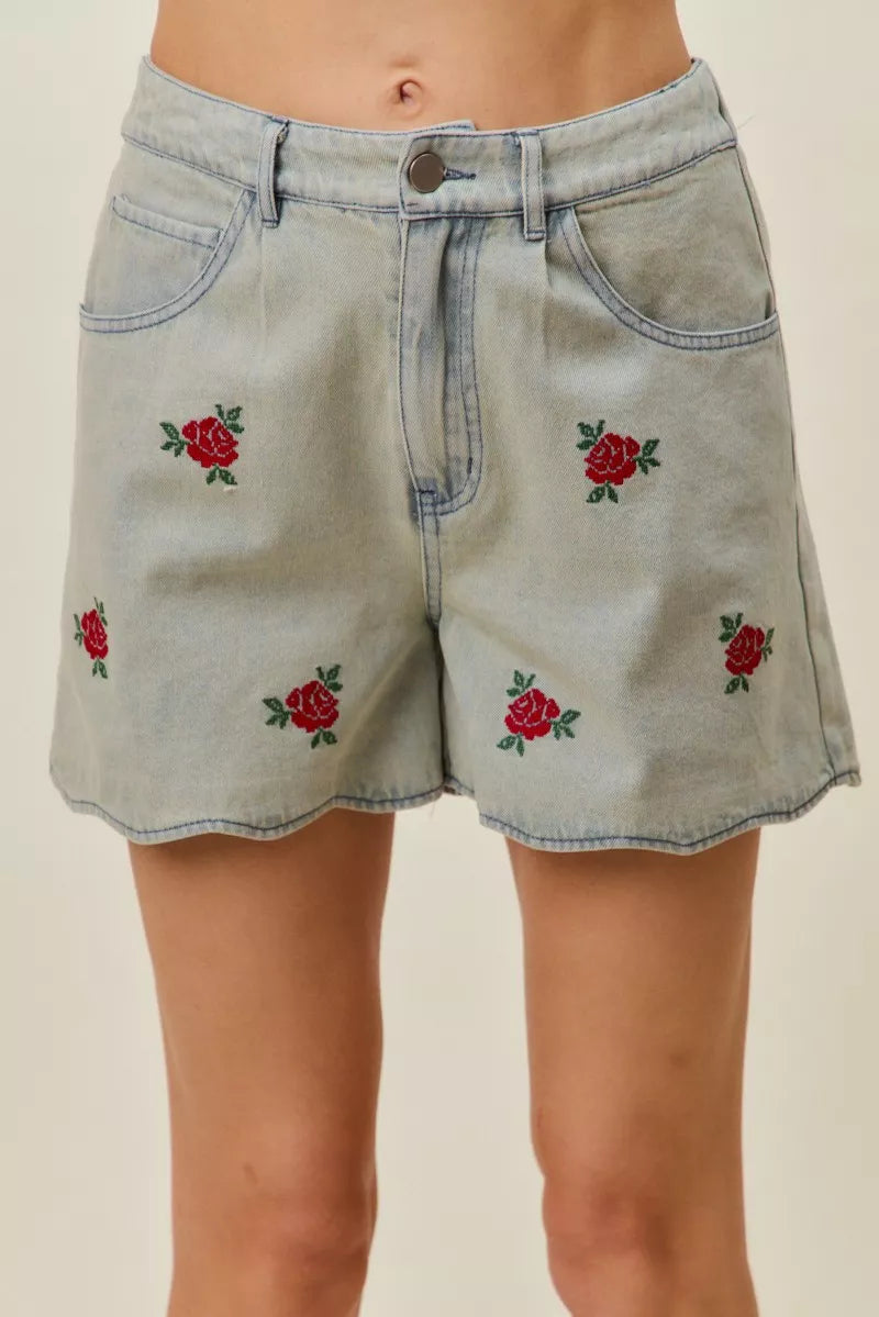 Light-wash denim shorts with rose embroidery and front button waist