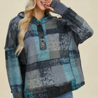 Plaid fleece hoodie with hood, half-zip, dropped shoulders, front diagonal view.