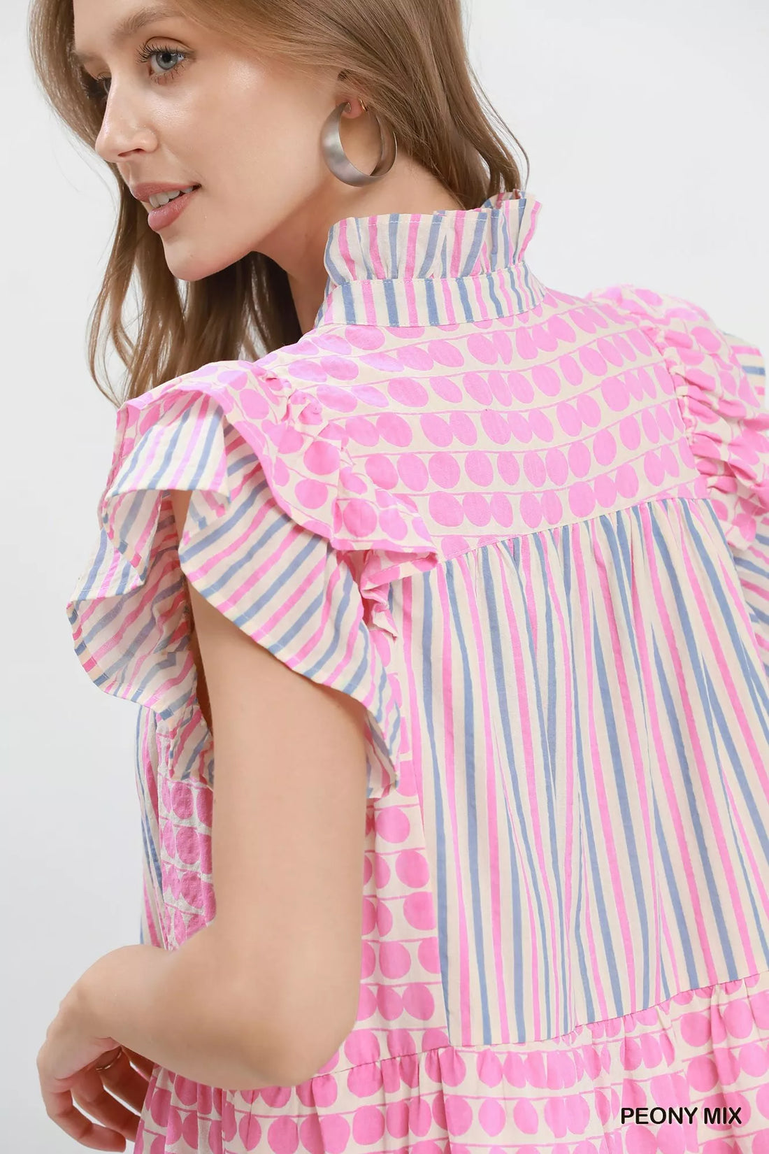 Pink and stripe tiered dress close-up of ruffle collar and flutter sleeve, dot print