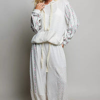 Ivory patchwork knit wide-leg pants with gathered elastic waistband and tassel tie accents