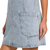 Light wash denim overall dress hem with front patch pocket and blue topstitching