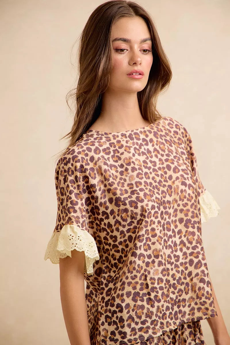 Leopard print ruffled top with eyelet lace cuff detail