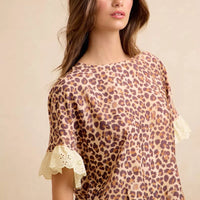 Leopard print ruffled top with eyelet lace cuff detail