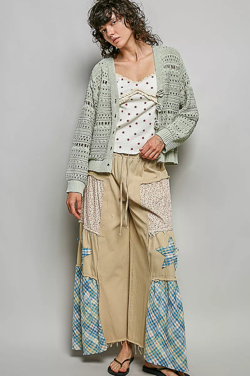 Light gray open-knit cardigan with button front and crochet rose appliques