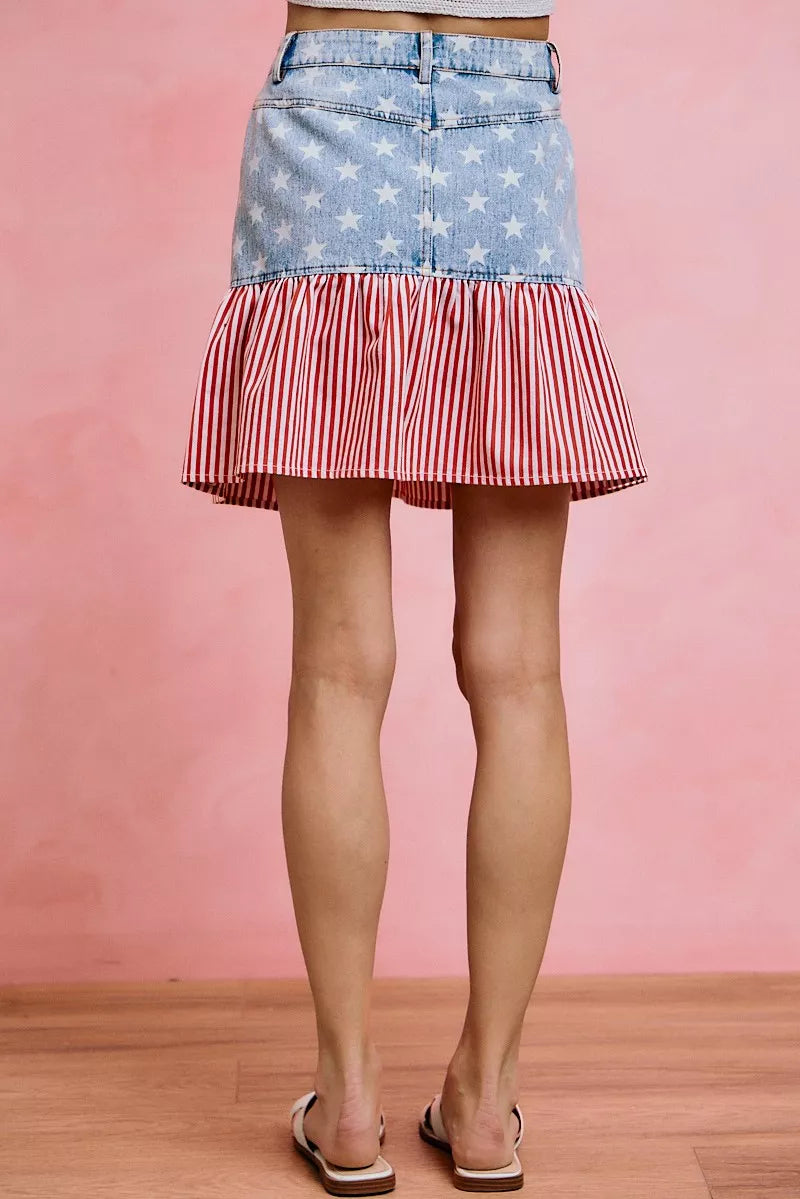 Blue denim mini skirt with scattered stars and layered red-and-white striped ruffle hem.
