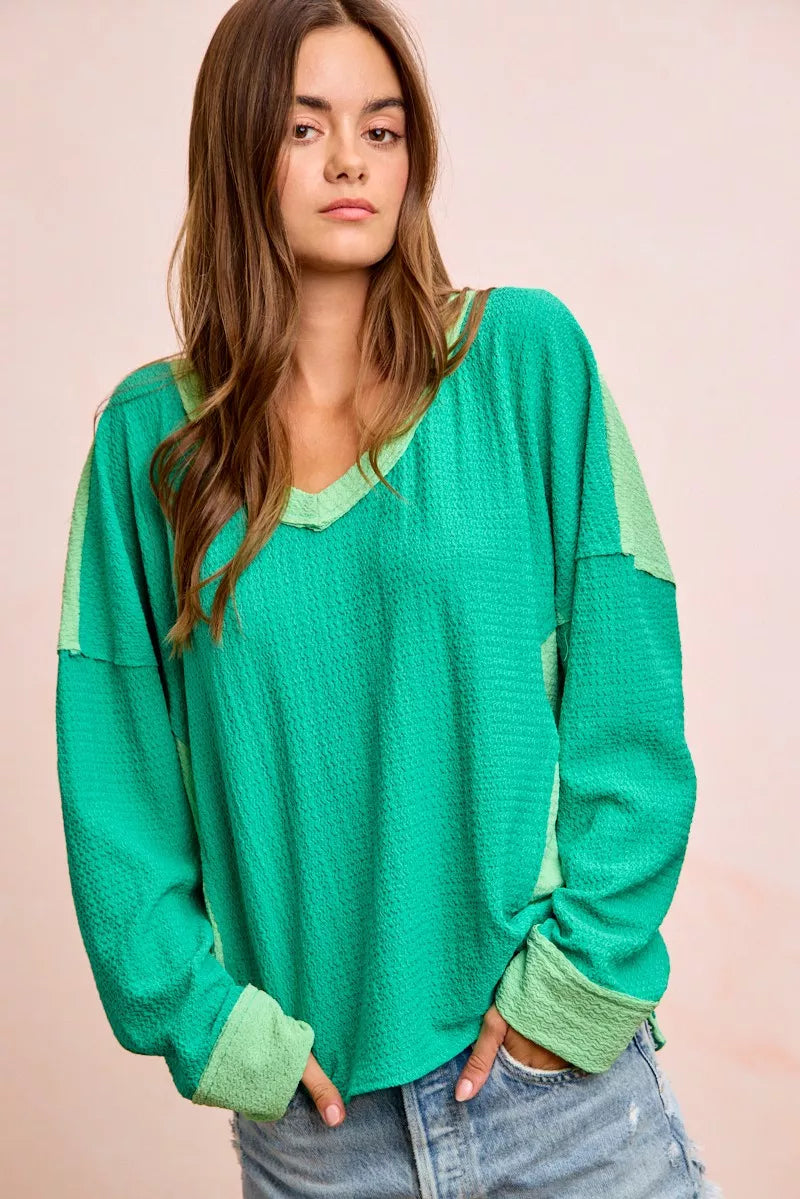 Textured jersey color block top with V-neck and emerald body, light green shoulder bands