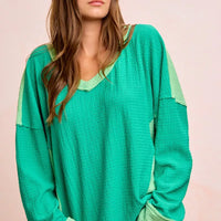 Textured jersey color block top with V-neck and emerald body, light green shoulder bands