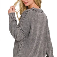 Washed dark gray oversized sweater, deep V-neck, long sleeves with ribbed hem