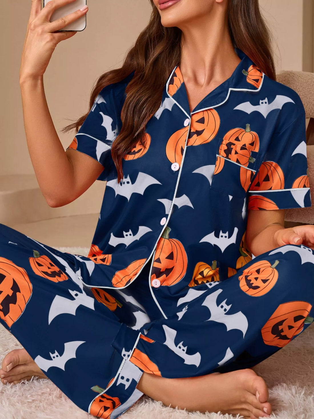 Navy button-down pajama set with pumpkin and bat print, short-sleeve top and matching pants