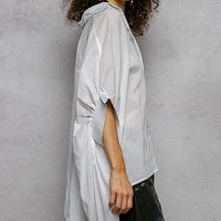 Ivory embroidered floral button-front shirt, side profile with relaxed draped sleeves