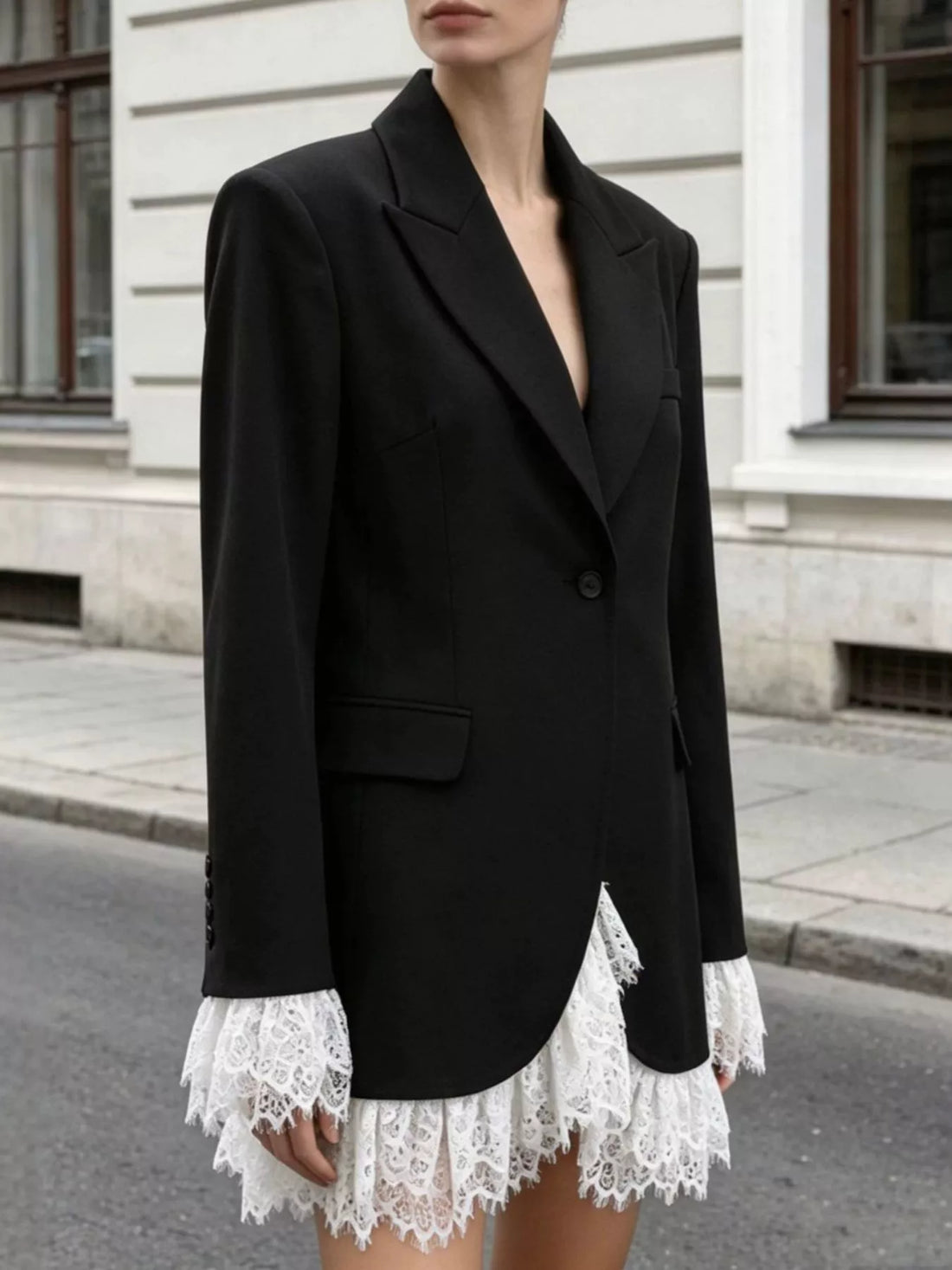 Black one-button blazer with lace-trim hem and front flap pockets