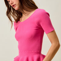 Hot pink ribbed knit peplum sweater top, draped peplum detail in view