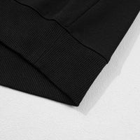 Black sweatshirt hem and ribbed sleeve cuff close-up