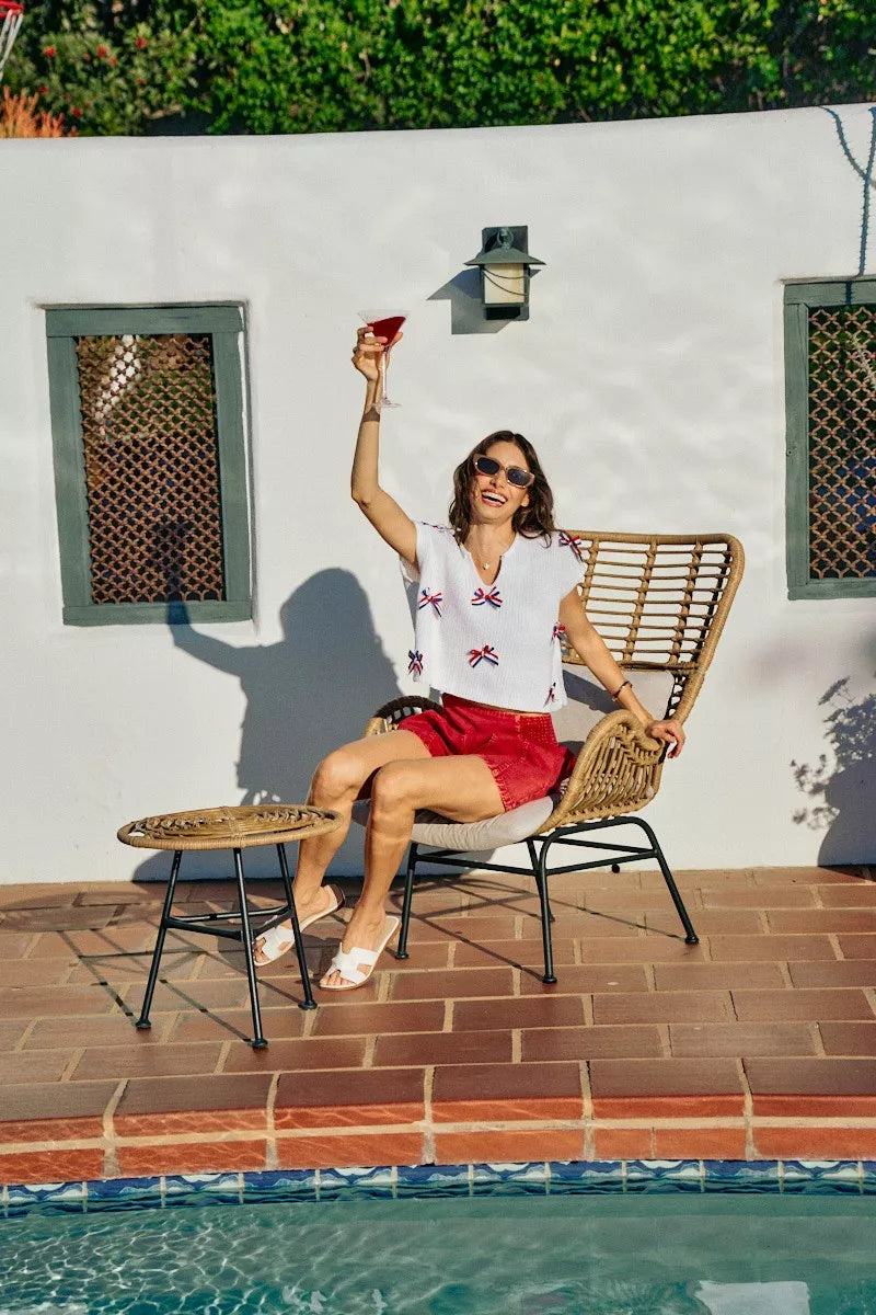 Off-white dolman sweater top with red-white-blue ribbon bow trim and V-neck